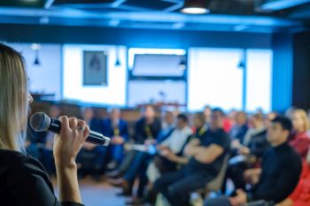 Female presenter speaks to audiences at workshop